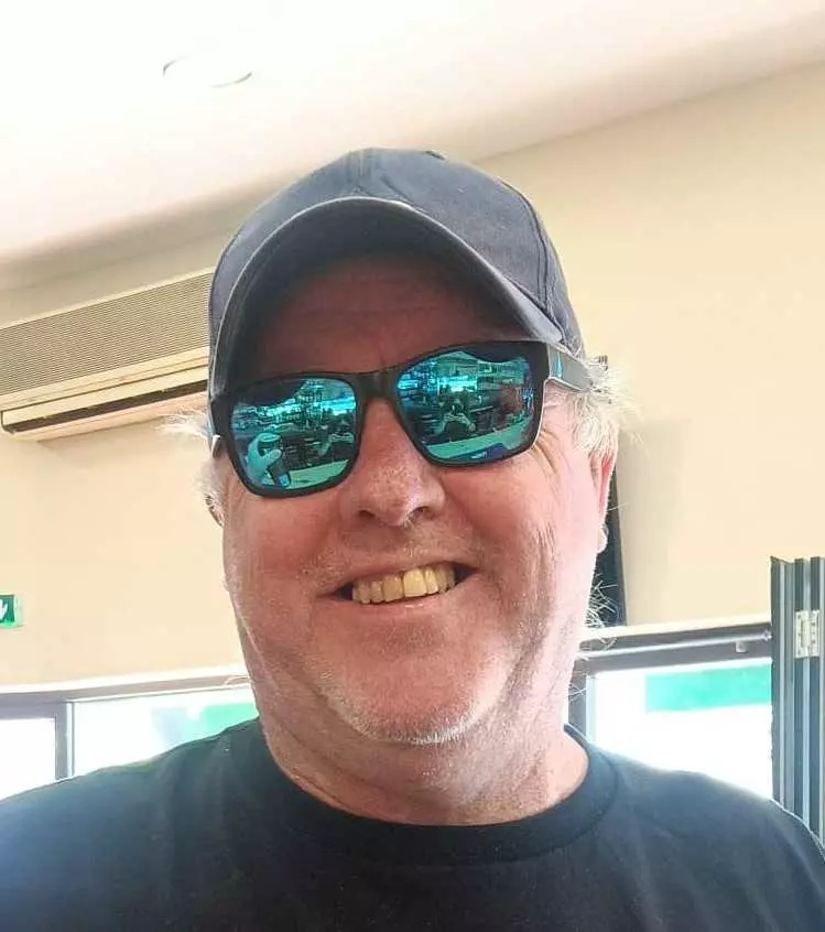 Close-up headshot of a smiling customer with our product