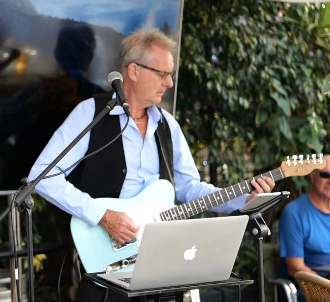 Our good friend Paul Atkin playing his guitar and singing in a live music event on The Hendrix terrace